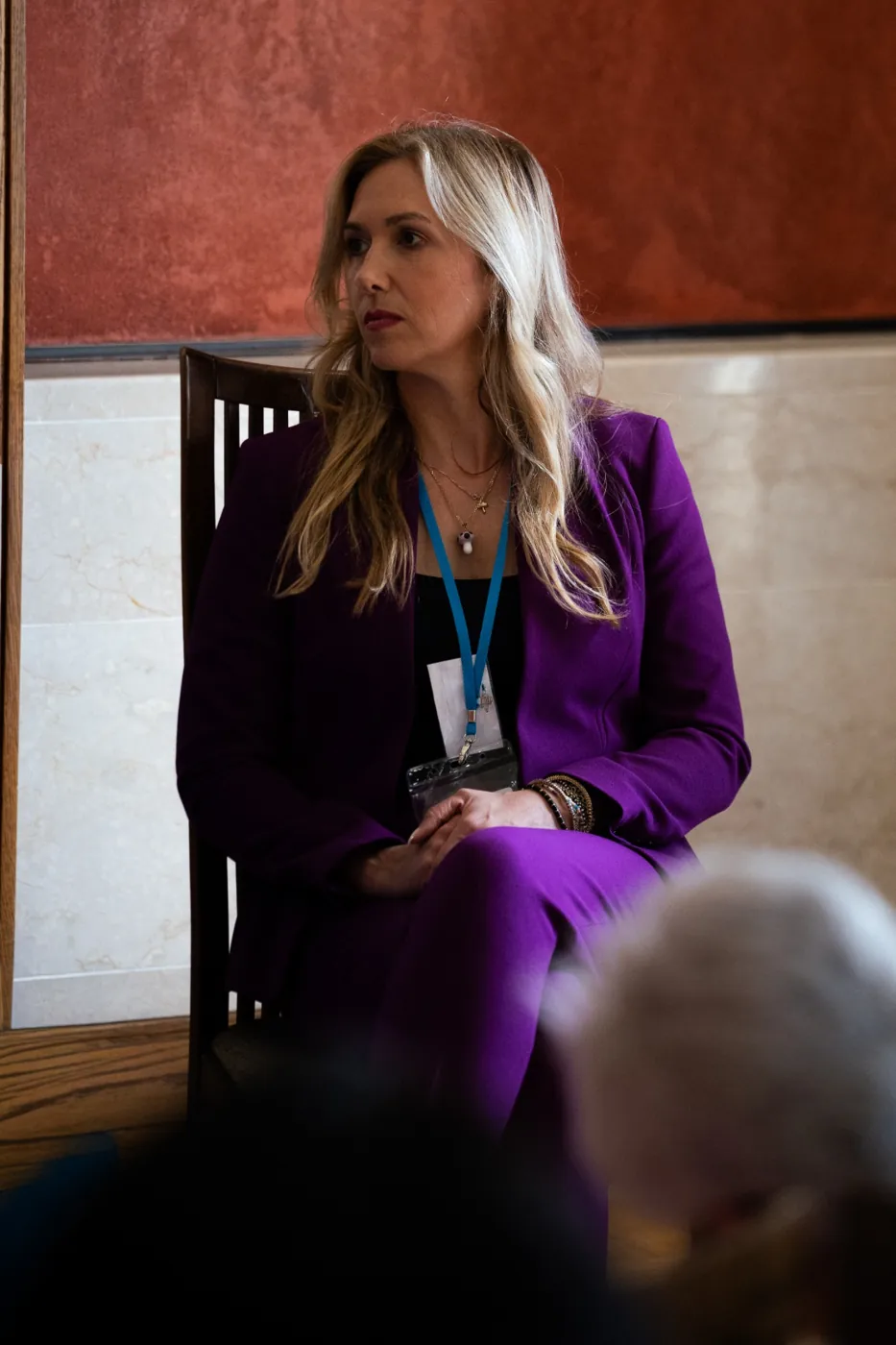 Panel speaker in purple addressing the Forum